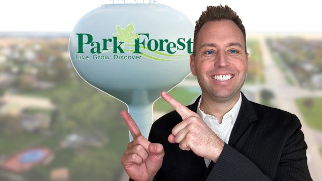 park forest illinois realtor tony anczer pointing to the park forest illinois water tower and the water tower has the Park Forest logo with words "Park Forest Live Grow Discover" and a leaf