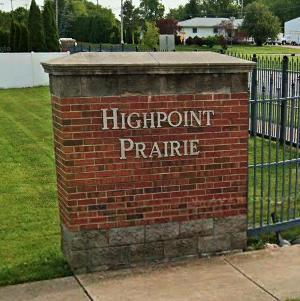 subdivision entrance sign for the Highpoint Prairie subdivision in Dyer Indiana. The sign is a roadside brick sign with lettering of "Highpoint Prairie"