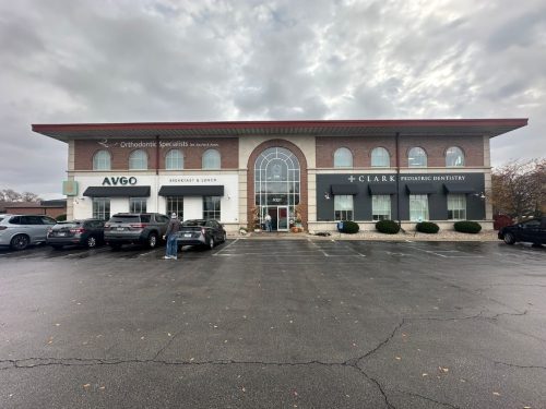 looking at the entrance of Avgo restaurant from standing in the parking lot looking at the building