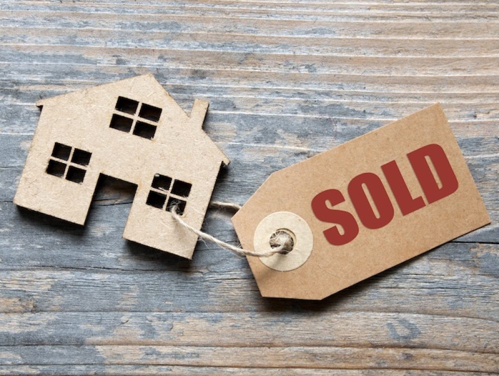 image of a house with a sold tag attached